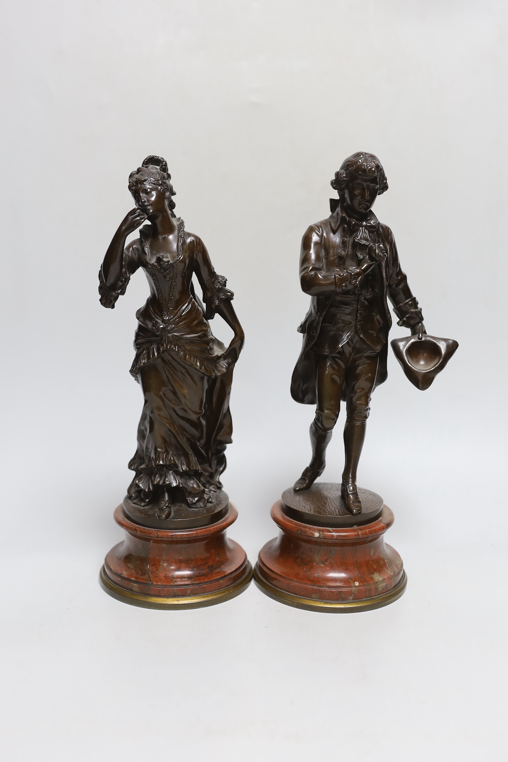 Karl Sterrer (1844-1918. A pair of bronze figures of a lady and gentlemen in 18th century dress, on rouge marble and ormolu mounted bases, signed, 31cm high